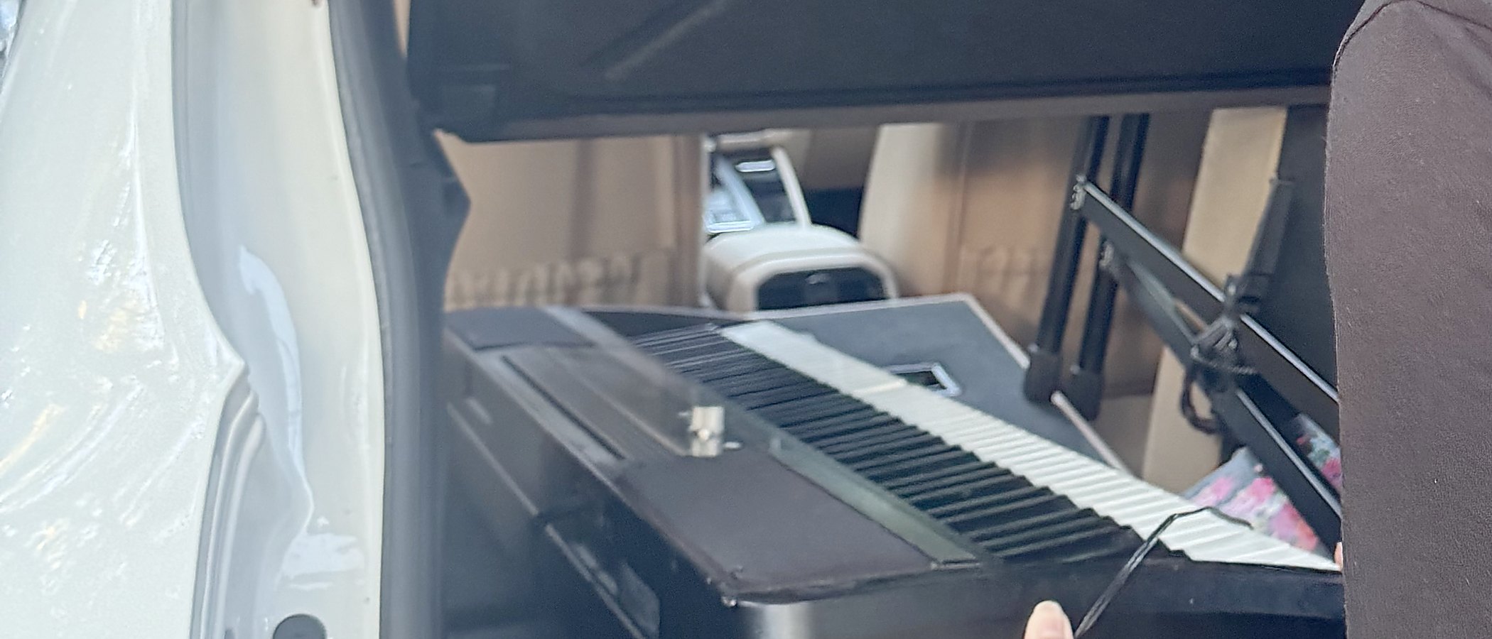 A donated keyboard in the back of a car, on its way to a student.